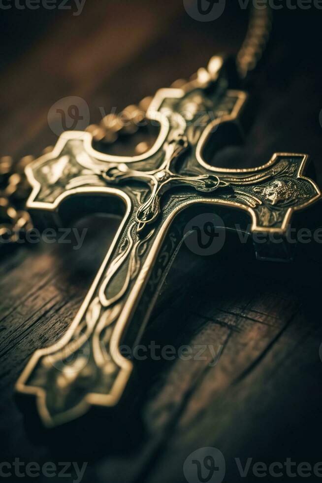 Close-up of a silver cross on a wooden table, shallow depth of field photo