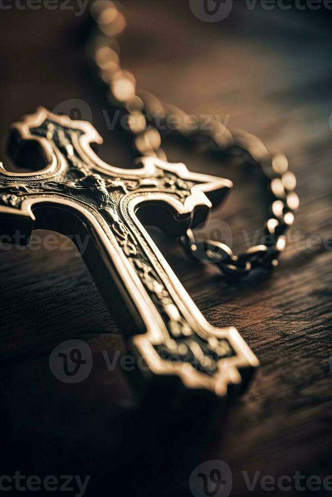 Close-up of a silver cross on a wooden table, shallow depth of field photo