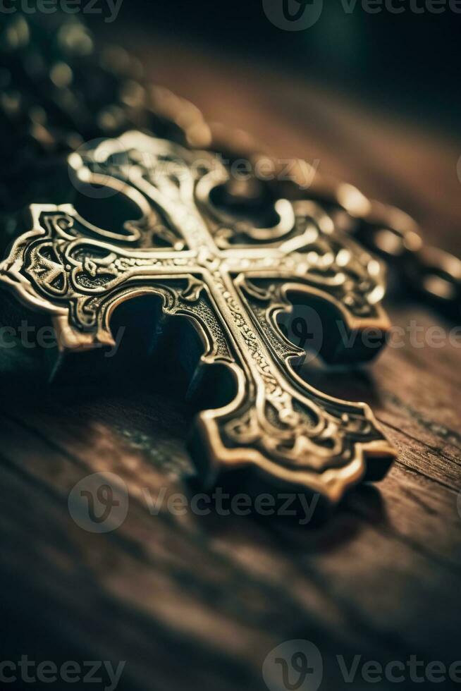 Close-up of a silver cross on a wooden table, shallow depth of field photo