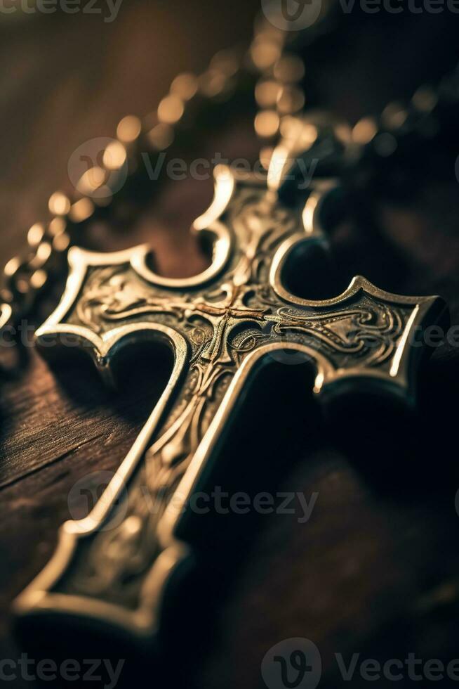 Close-up of a silver cross on a wooden table, shallow depth of field photo