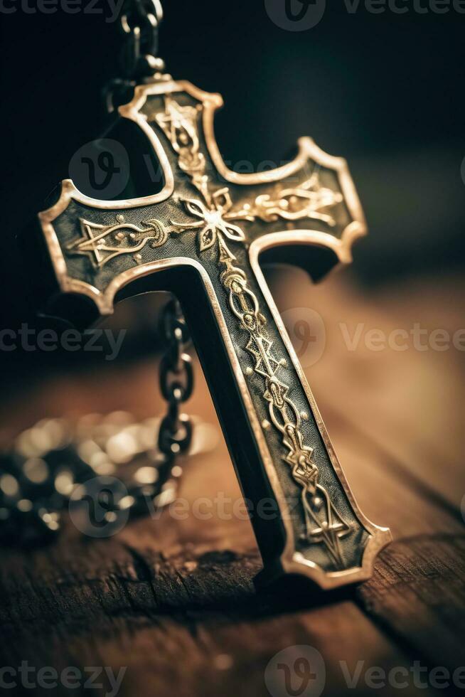 Close-up of a silver cross on a wooden table, shallow depth of field photo