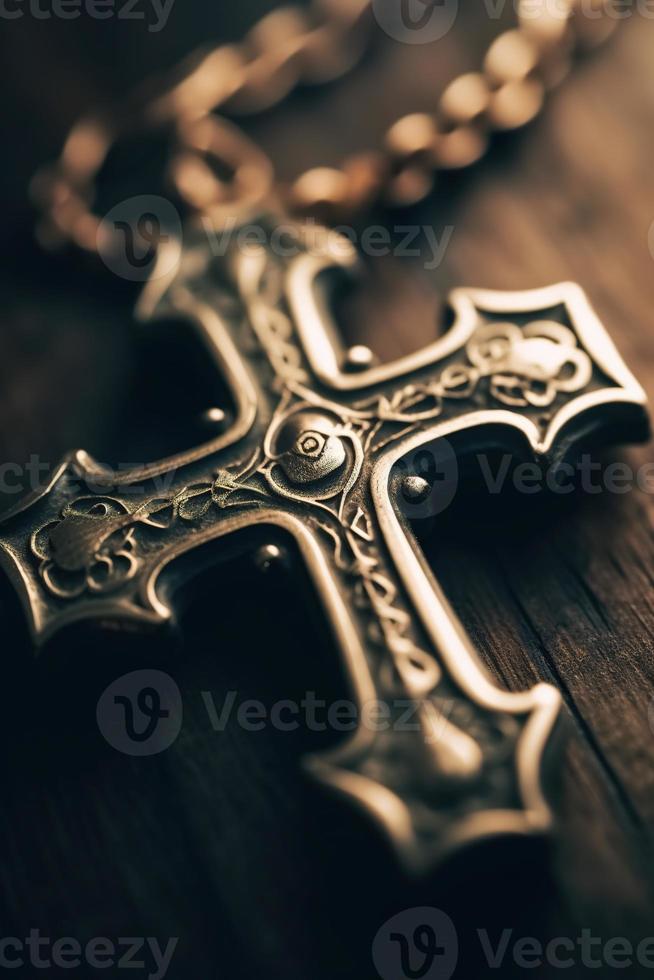 Close-up of a silver cross on a wooden table, shallow depth of field photo