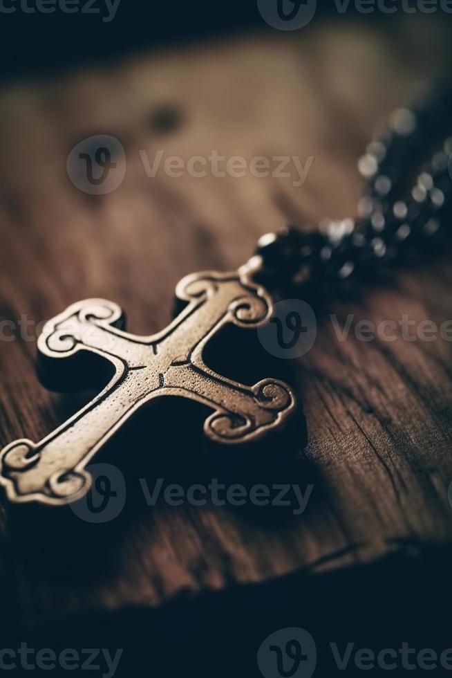 Close-up of a silver cross on a wooden table, shallow depth of field photo