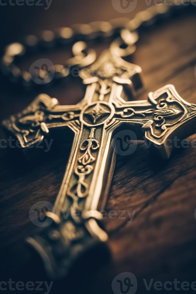 Close-up of a silver cross on a wooden table, shallow depth of field photo