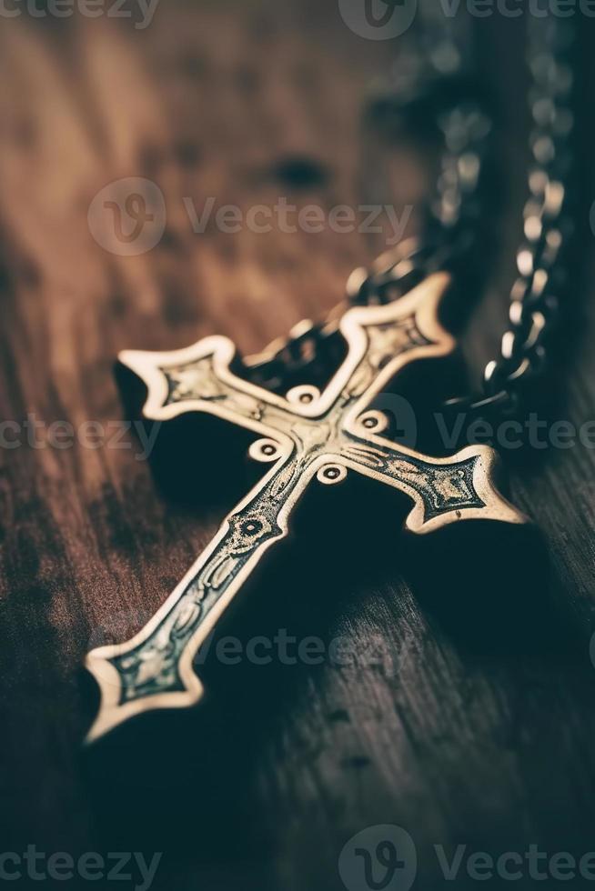 Close-up of a silver cross on a wooden table, shallow depth of field photo