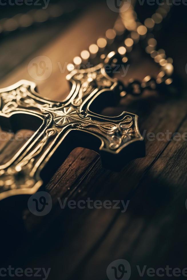 Close-up of a silver cross on a wooden table, shallow depth of field photo