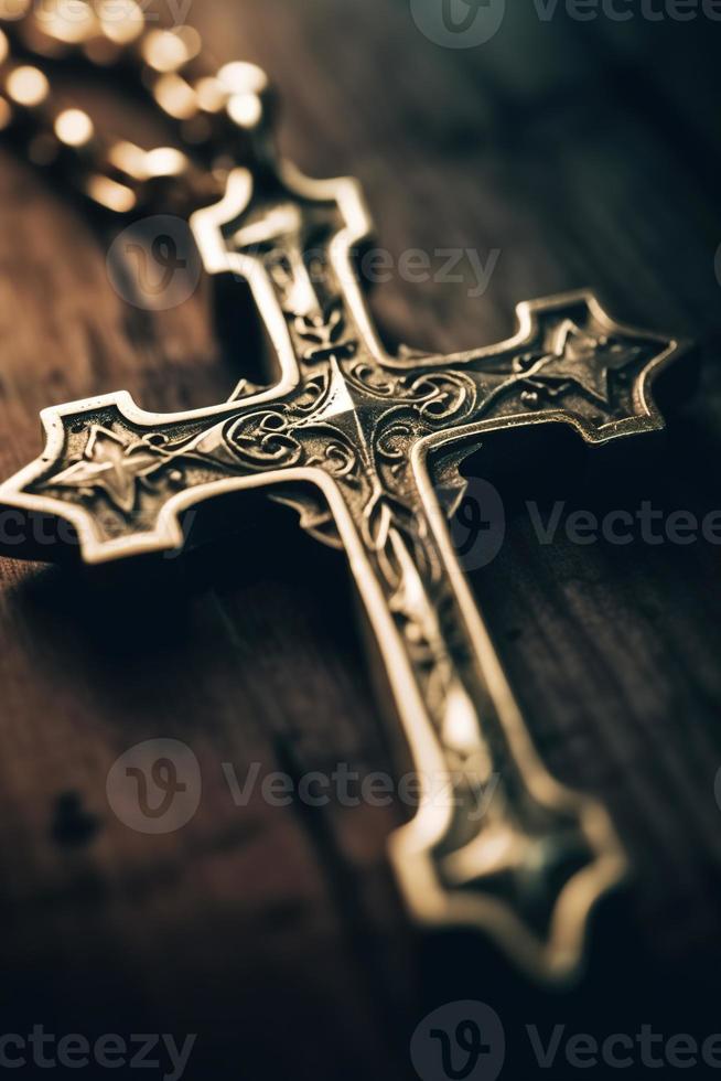 Close-up of a silver cross on a wooden table, shallow depth of field photo