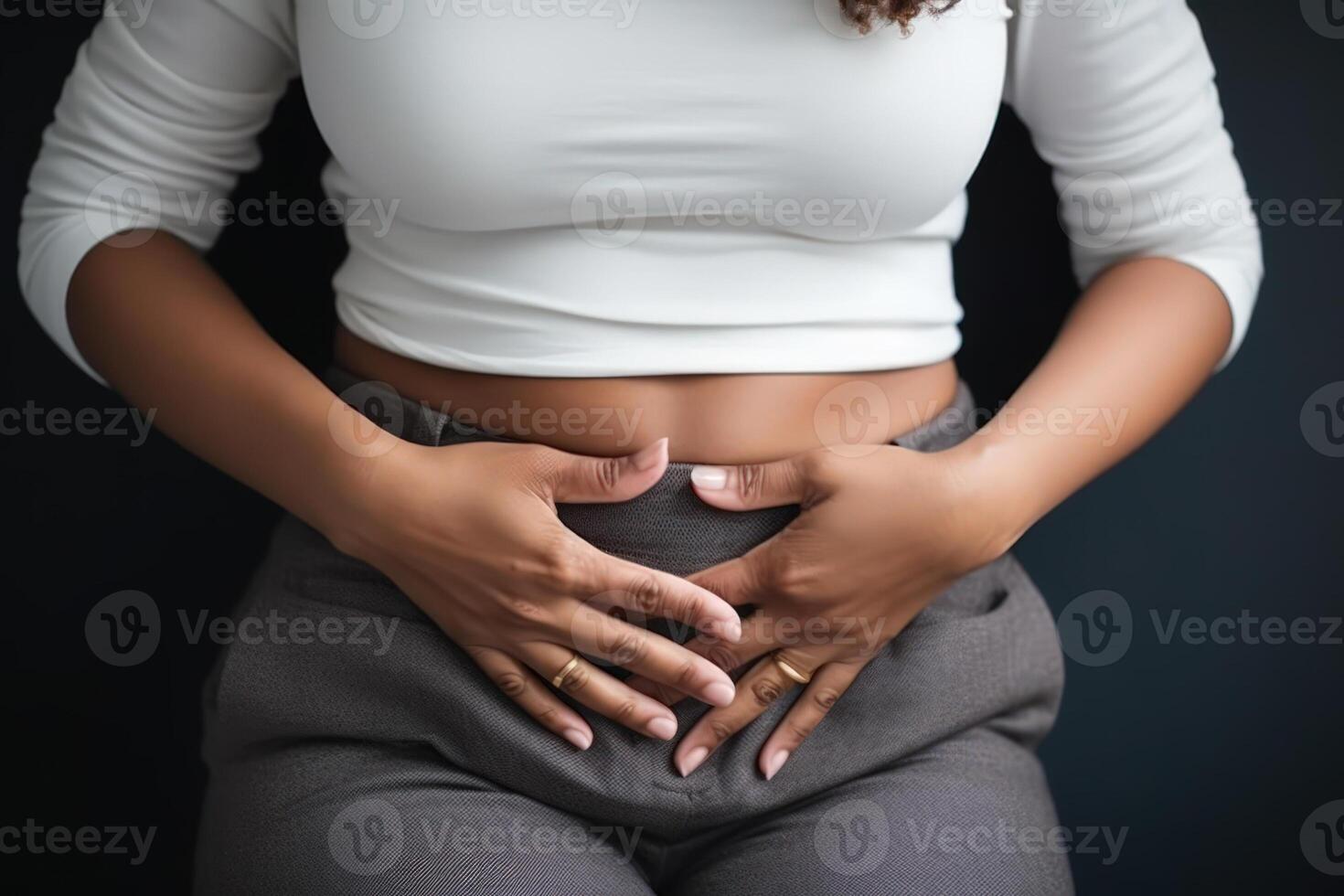pain from cramps in the lower abdomen, woman hands on stomach, pain during menstruation photo