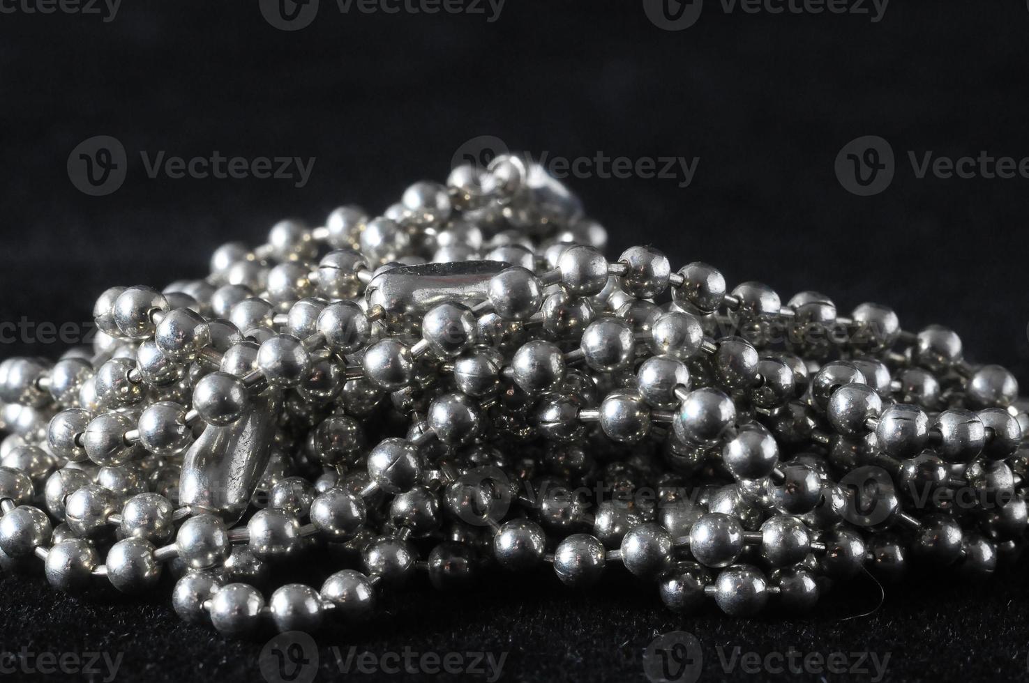 Silver beads on black background photo