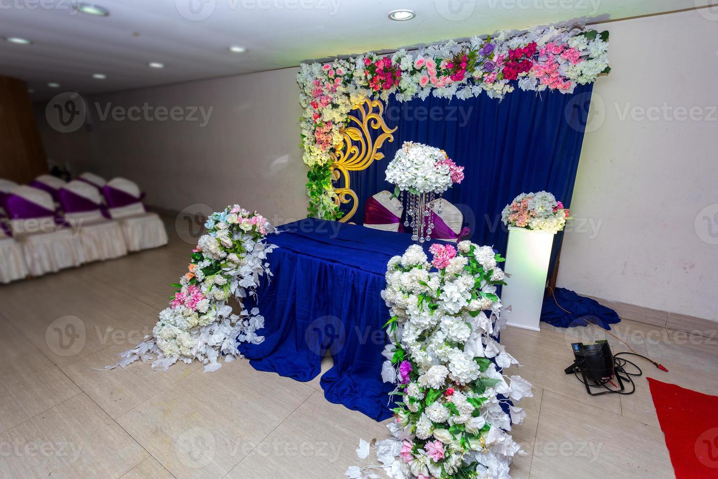 Artificial colorful paper flowers with navy-blue color based wedding stage decoration. photo