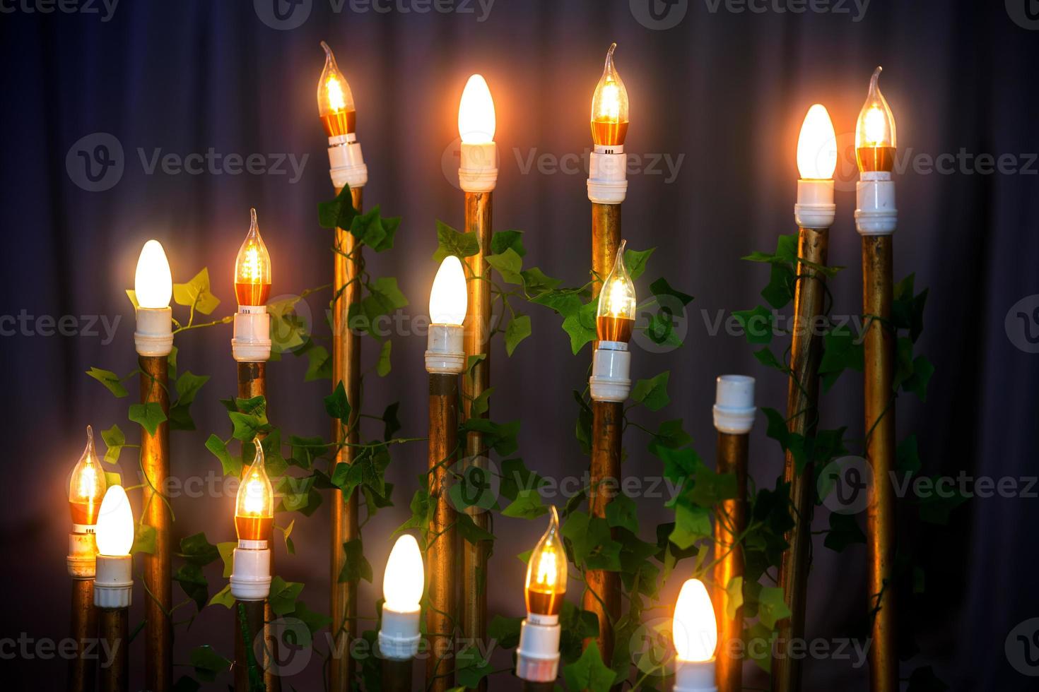 Decorative antique Edison style filament light bulbs standing on wedding stage decoration background. photo