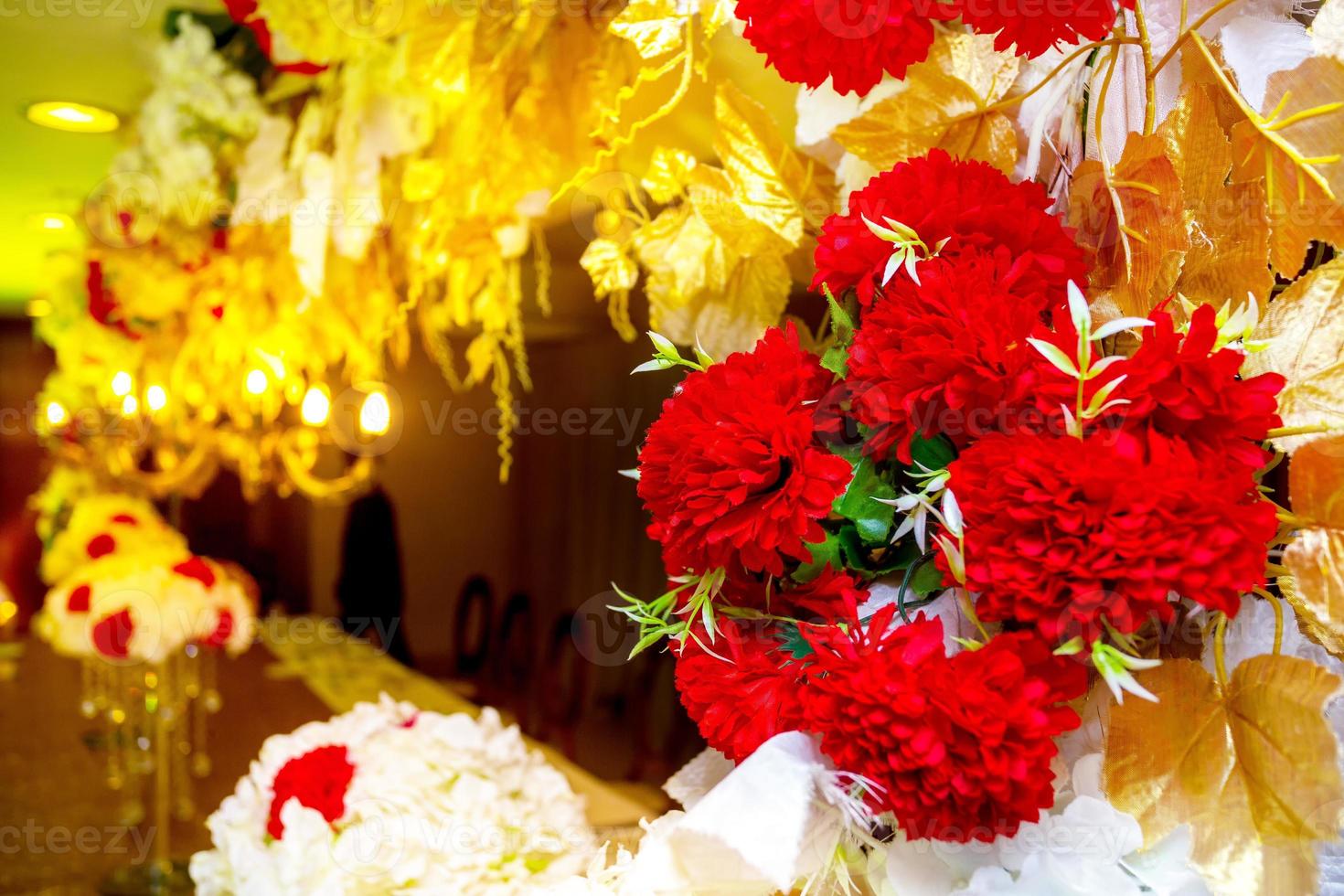 Colorful Red and golden flower and lighting wedding stage decoration. Plastic artificial flower. wedding decoration. photo