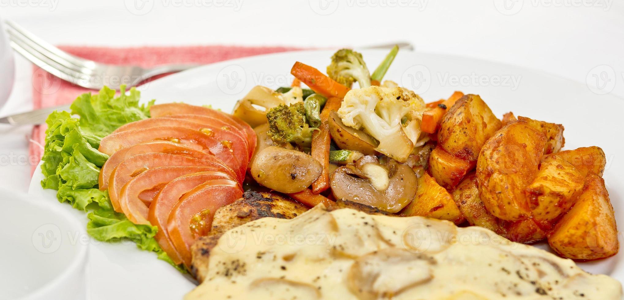 Peri peri Chicken with Button mushroom gravy, Saute Vegetables, Spicy fried Potatoes with Tomato Lettuce Salad. photo