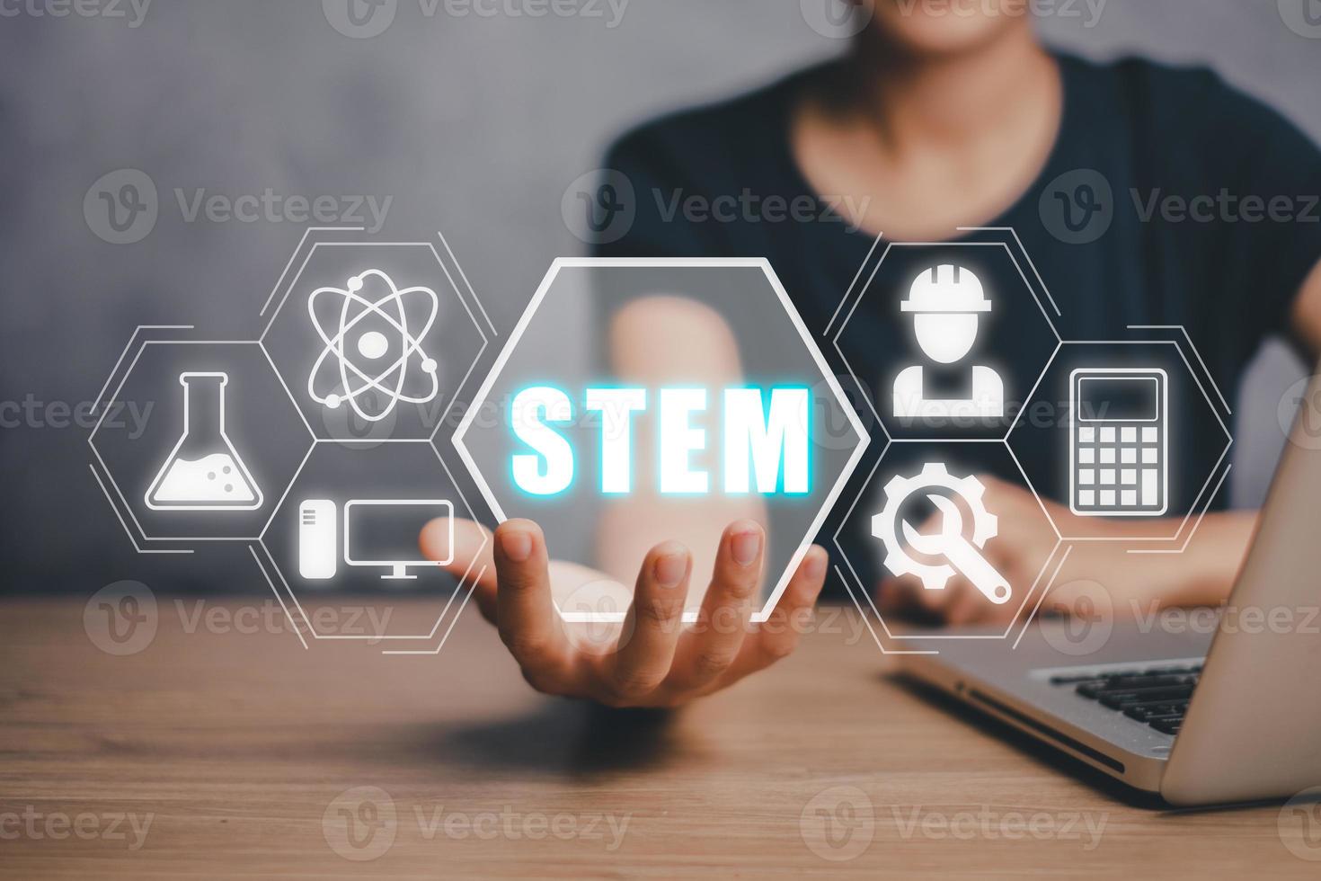 STEM concept, science, technology, engineering, mathematics, Business person hand holding STEM icon on virtual screen. photo