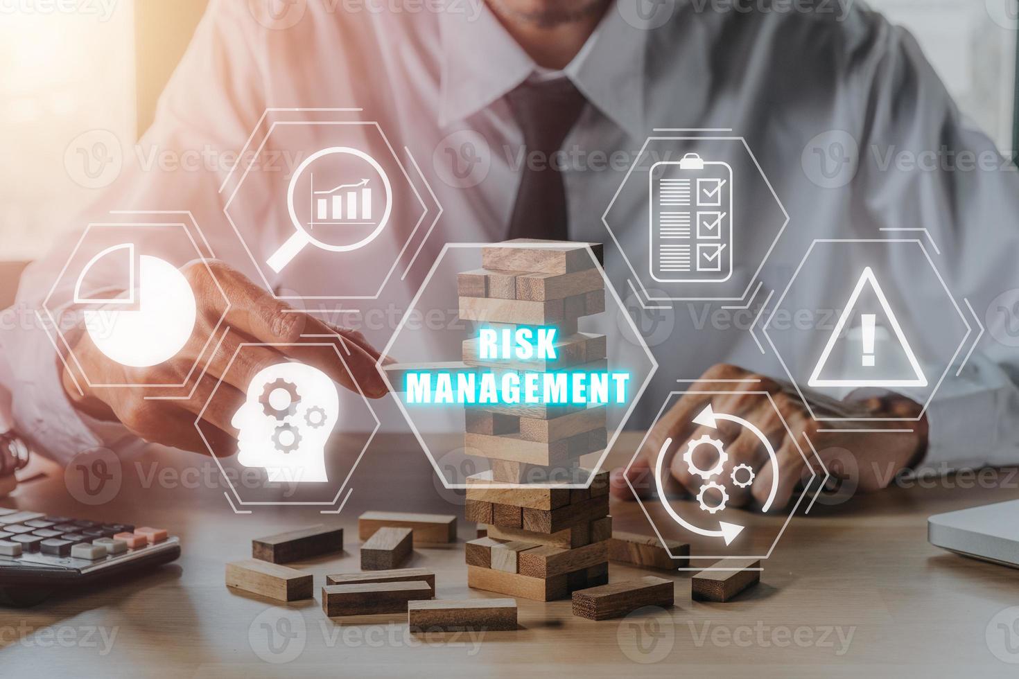 Risk management strategy plan finance investment internet business technology concept, Person hand piling up and stacking a wooden block with icons risk management on virtual screen. photo