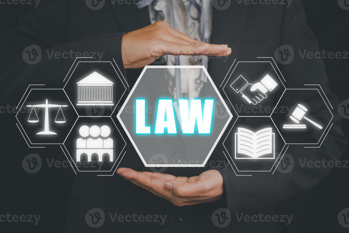 Justice and law concept, Business person hand holding law icon on virtual screen. photo