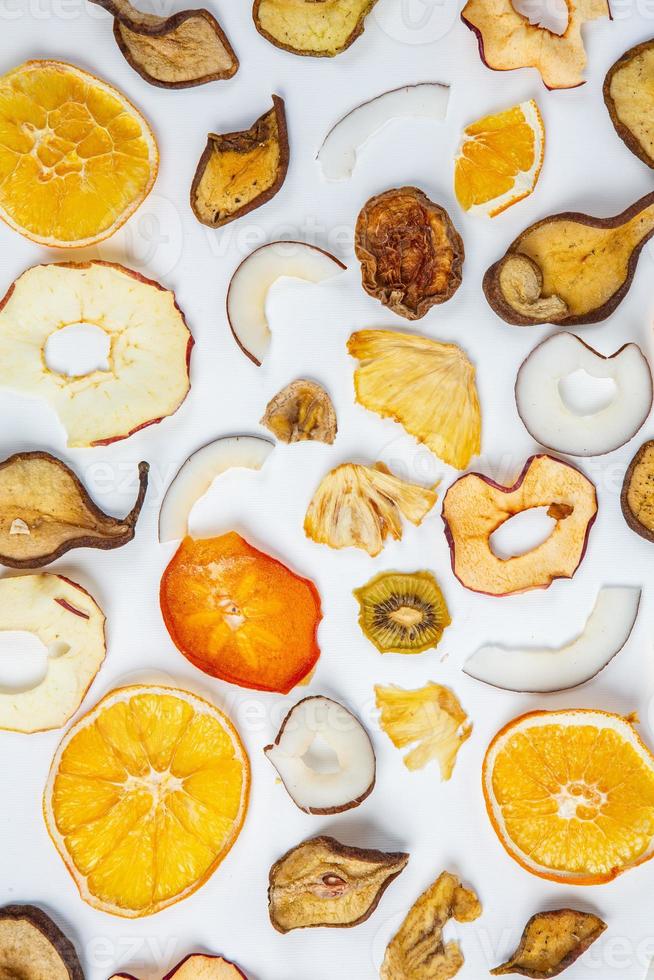 Dried fruits isolated on white background. Healthy eating concept. Top view. Healthy vegetarian food concept. Dried fruit chips. photo