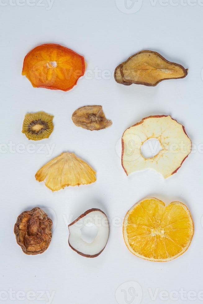 Dried fruits isolated on white background. Healthy eating concept. Top view. Healthy vegetarian food concept. Dried fruit chips. photo