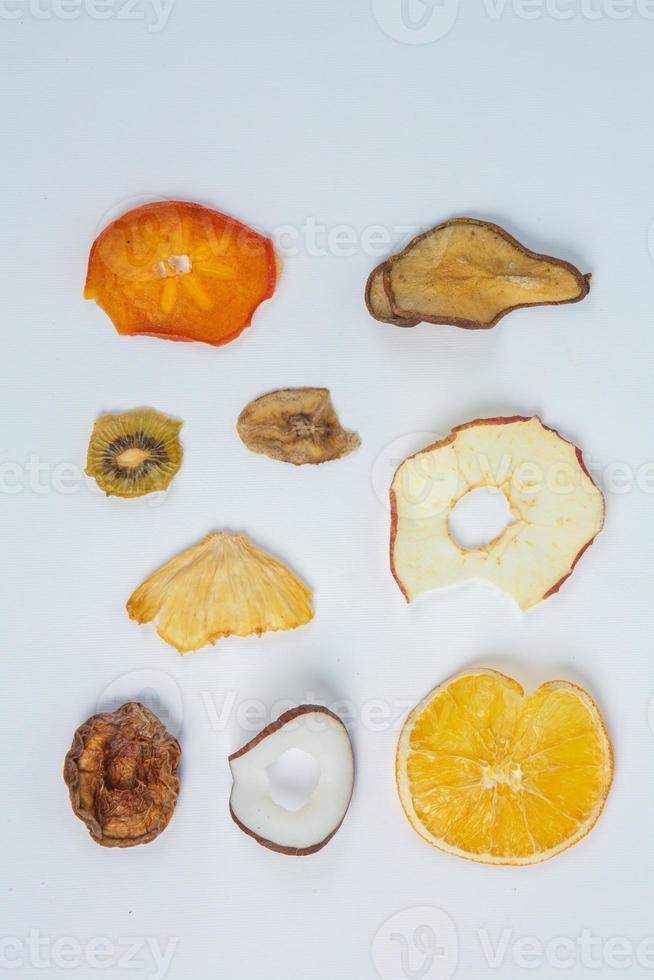 Dried fruits isolated on white background. Healthy eating concept. Top view. Healthy vegetarian food concept. Dried fruit chips. photo