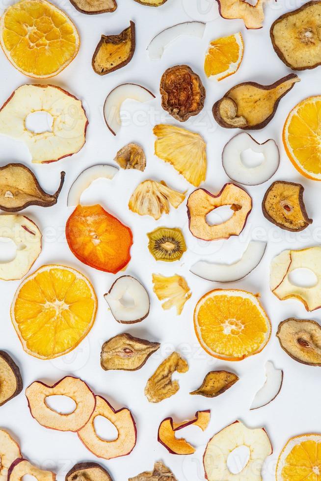 Dried fruits isolated on white background. Healthy eating concept. Top view. Healthy vegetarian food concept. Dried fruit chips. photo