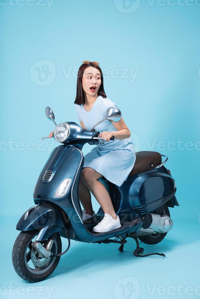 Young Asian woman on motorbike photo
