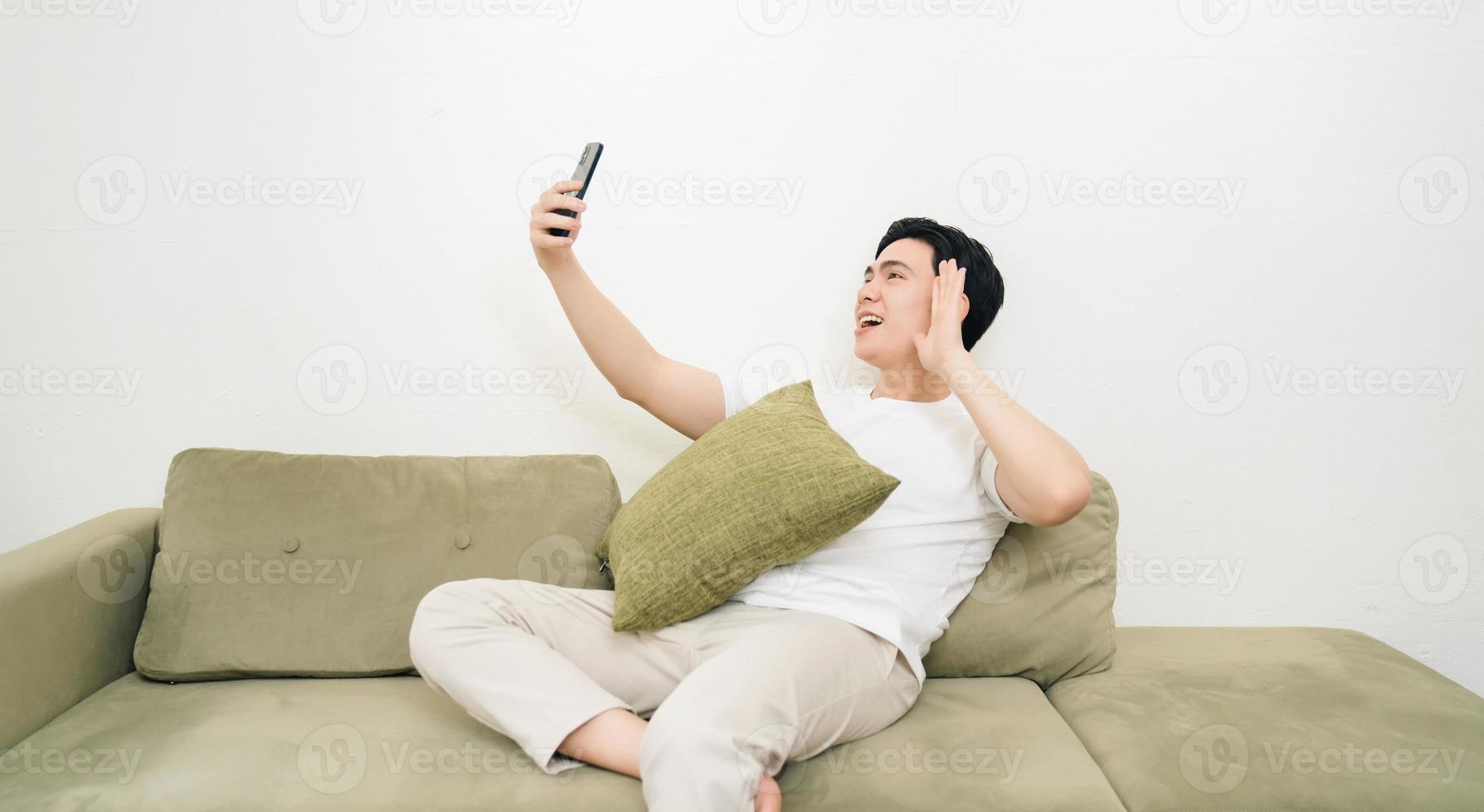 Image of young Asian man at home photo