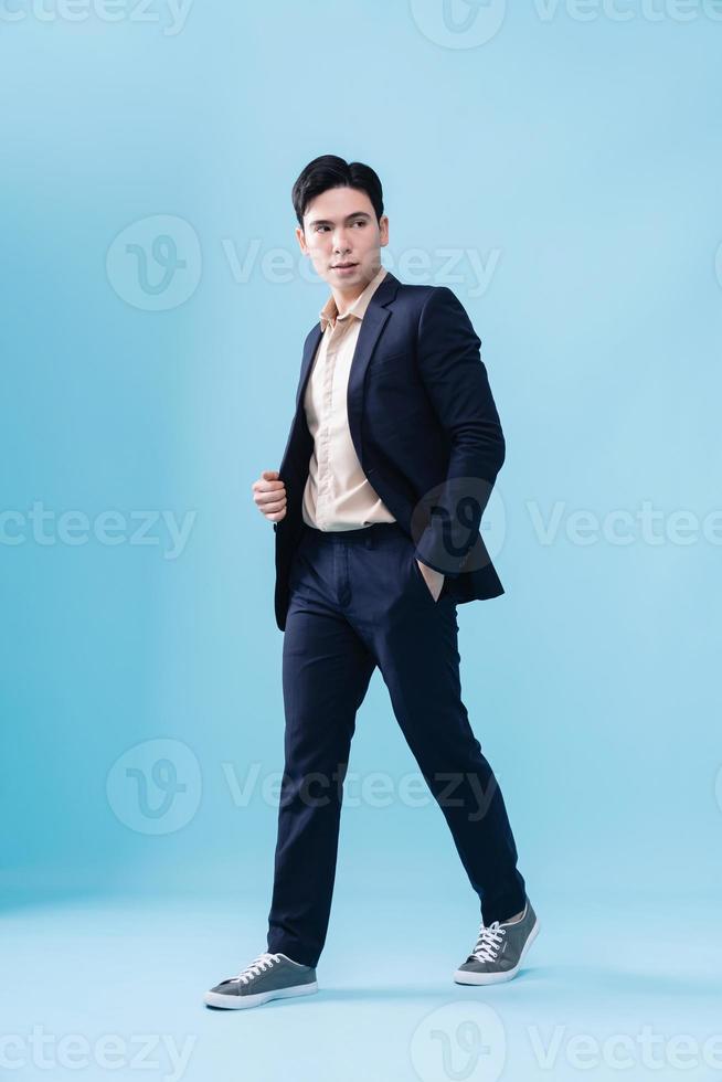 Photo of young Asian businessman on background
