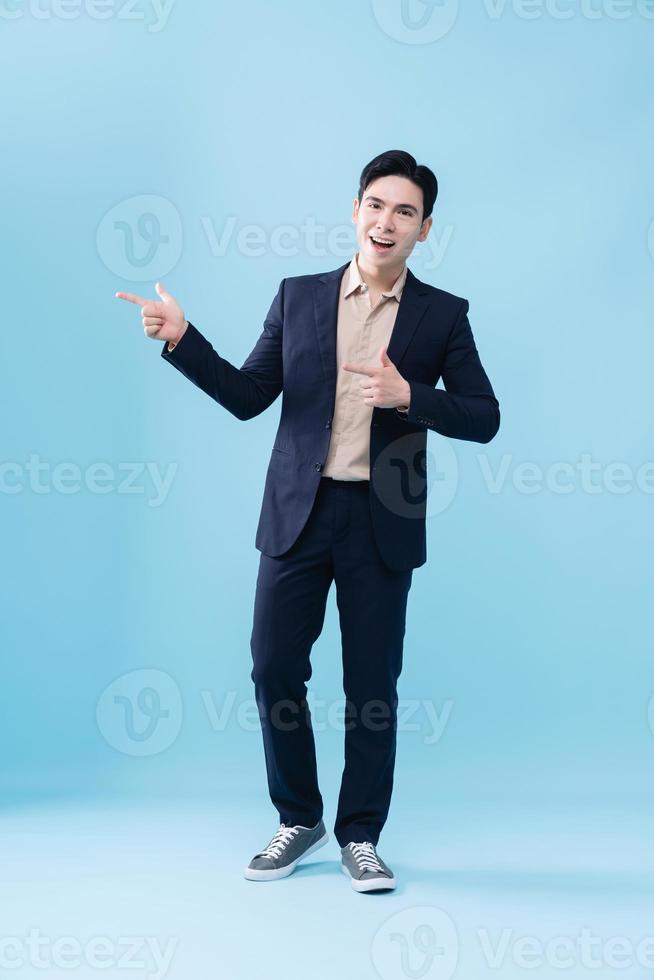 Photo of young Asian businessman on background