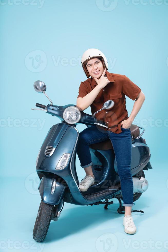 Image of yougn Asian man on motorbike photo