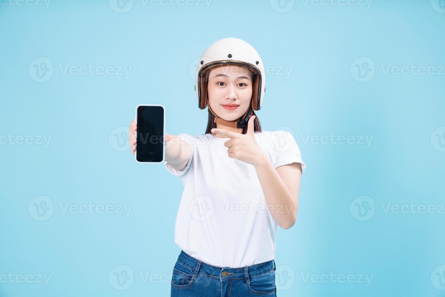 Young Asian woman wearing helmet on background photo