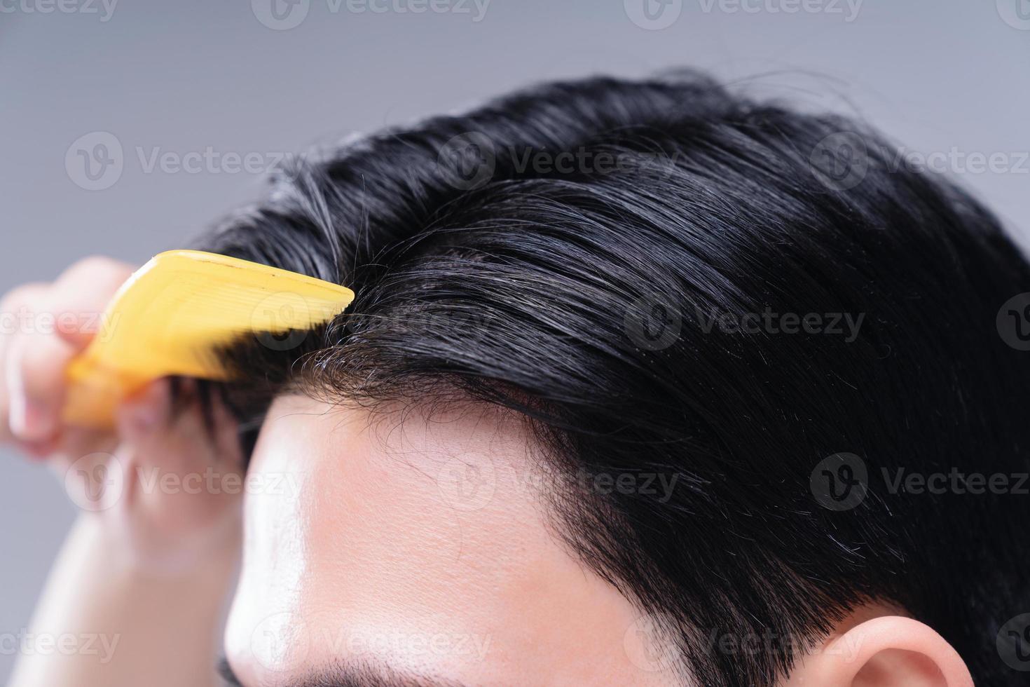Image of young Asian man hair care on background photo