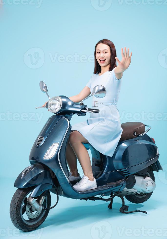 Young Asian woman on motorbike photo