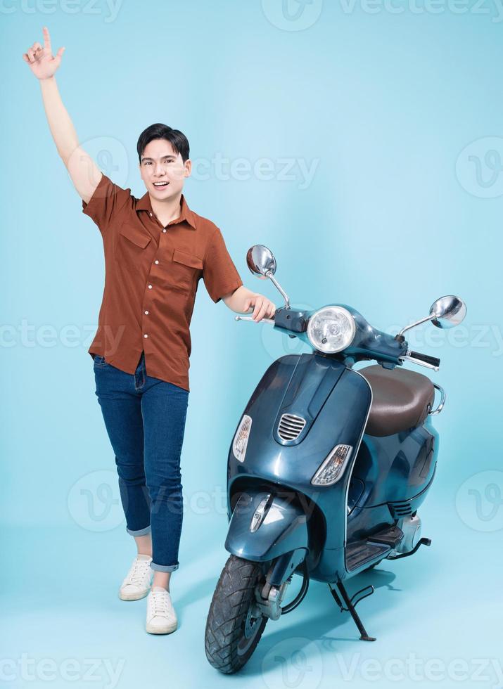 Image of yougn Asian man on motorbike photo
