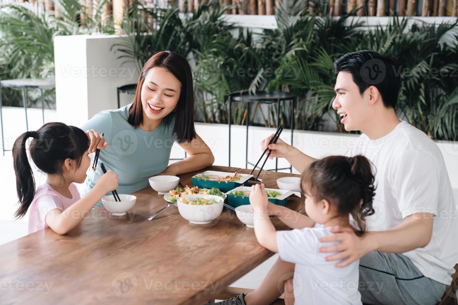 Image of Asian family eating lunch together photo