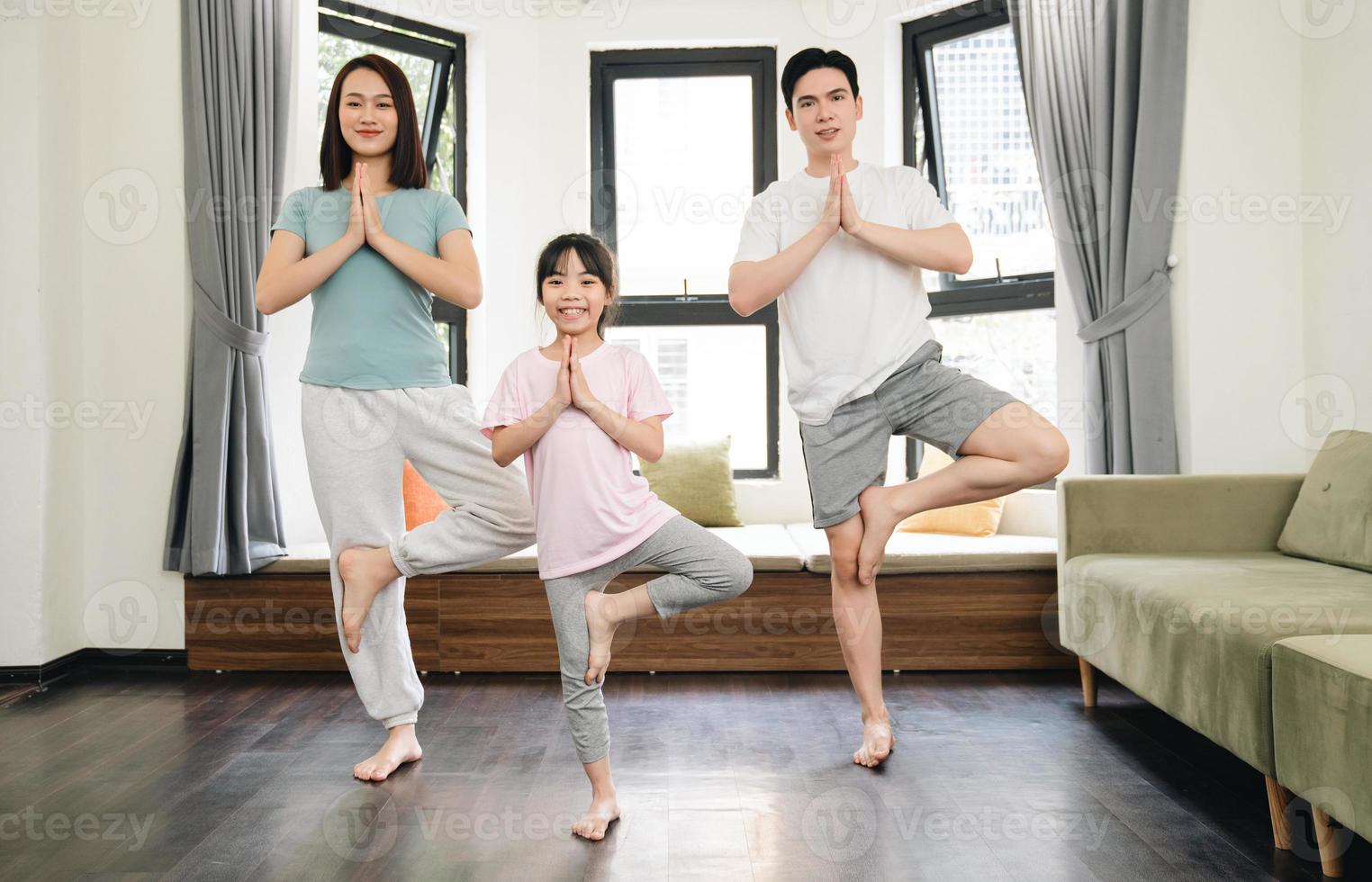 Young Asian family exercise at home photo