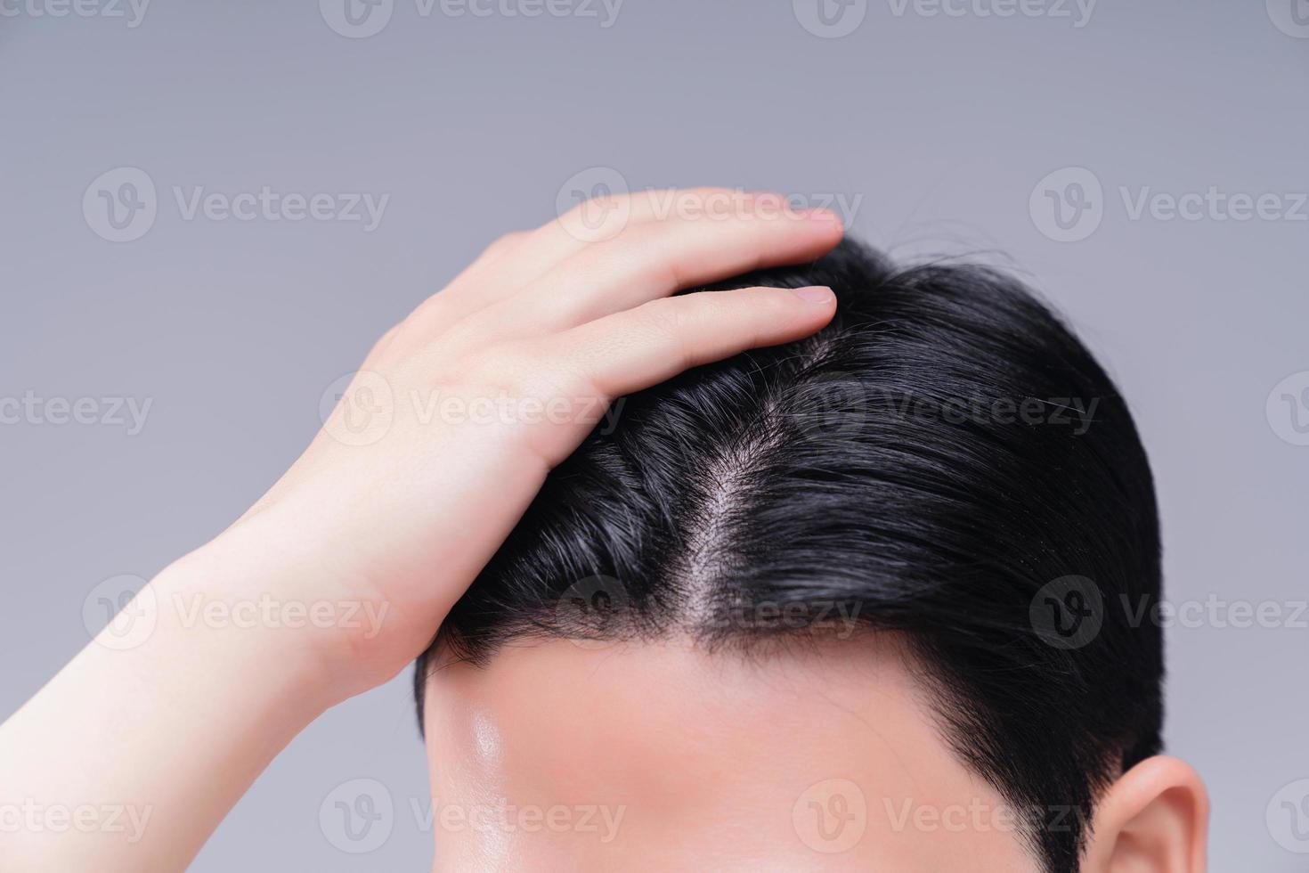 Image of young Asian man hair care on background photo