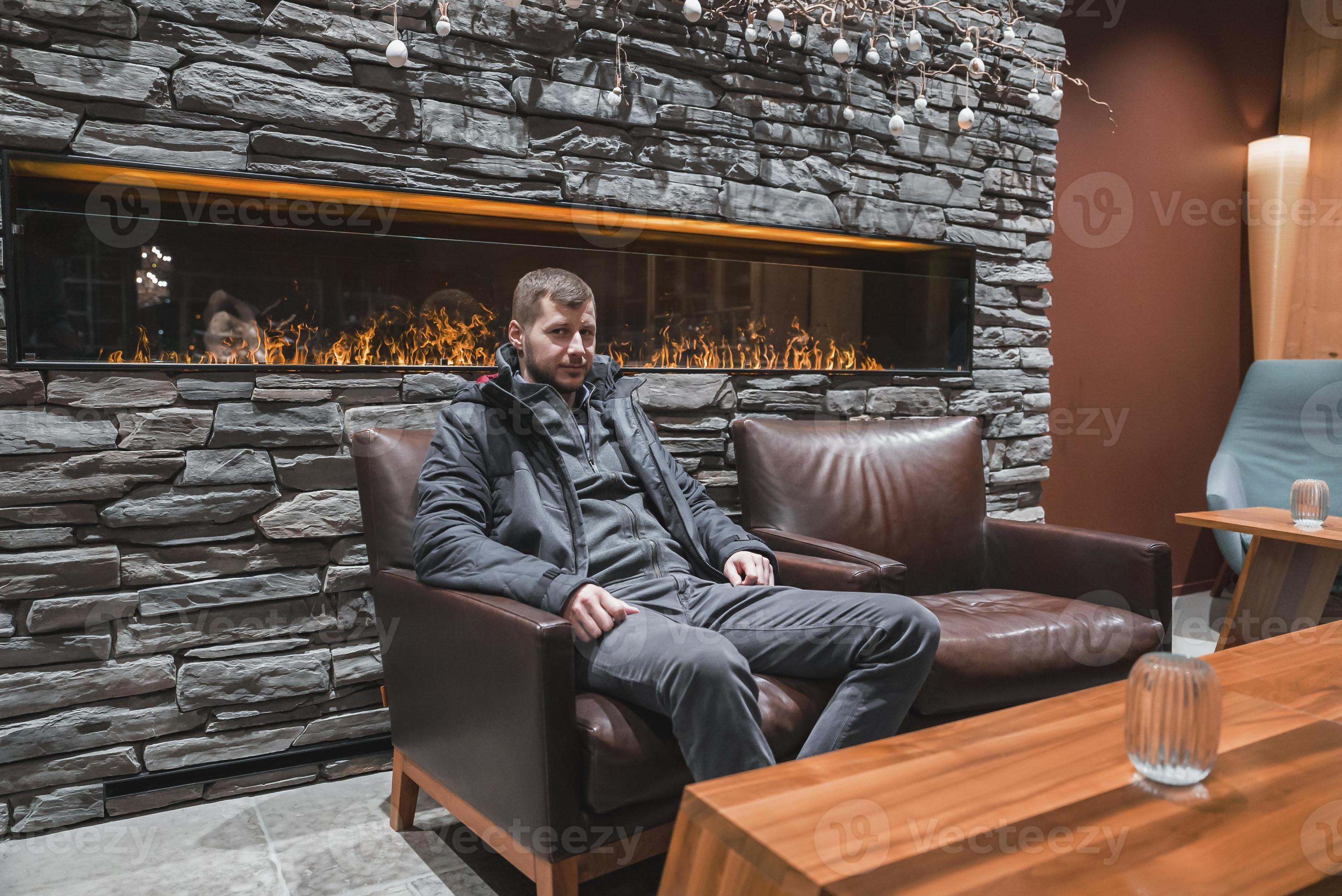 Male tourist sitting in armchair at luxury hotel during vacation