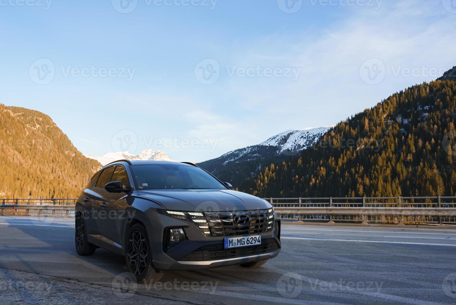 Car parked on road with mountain range in background photo
