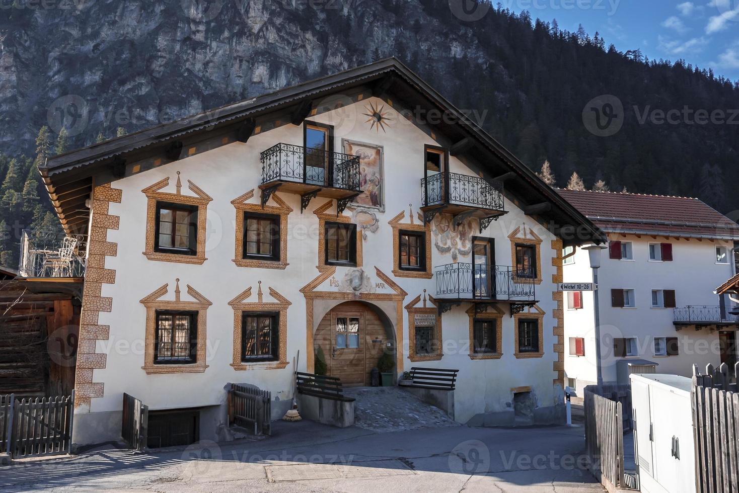 Facade of residential building with mountain in background photo