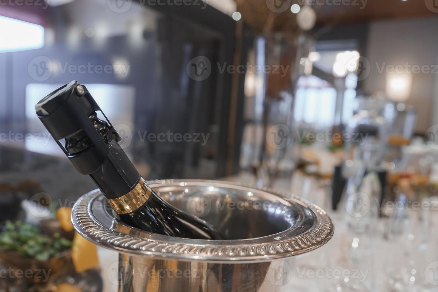 Champagne bottle in container at luxury hotel photo