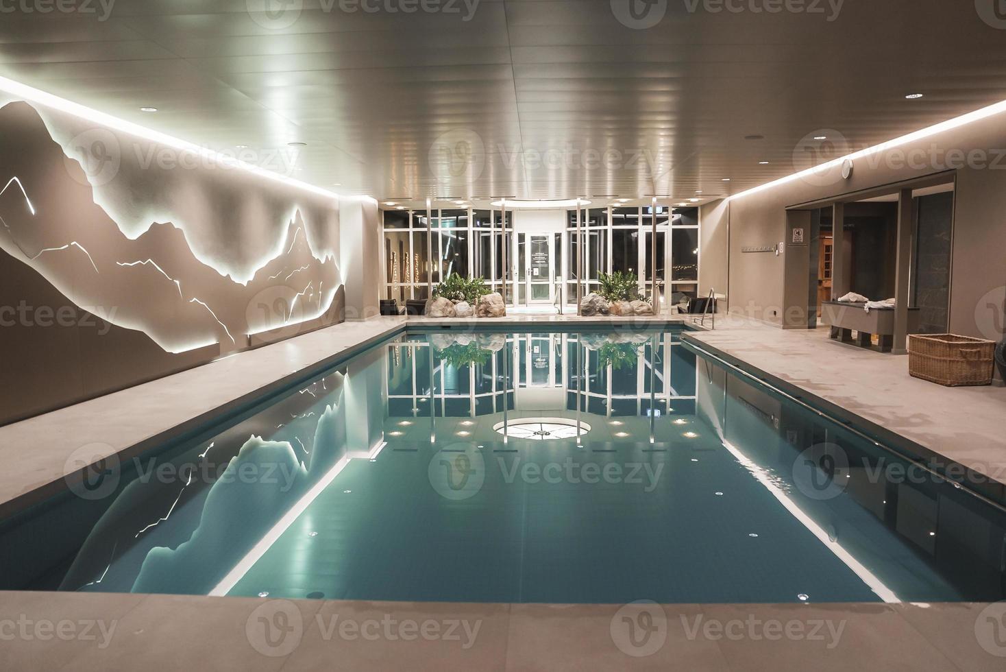 Interior of luxury hotel with swimming pool and decor photo