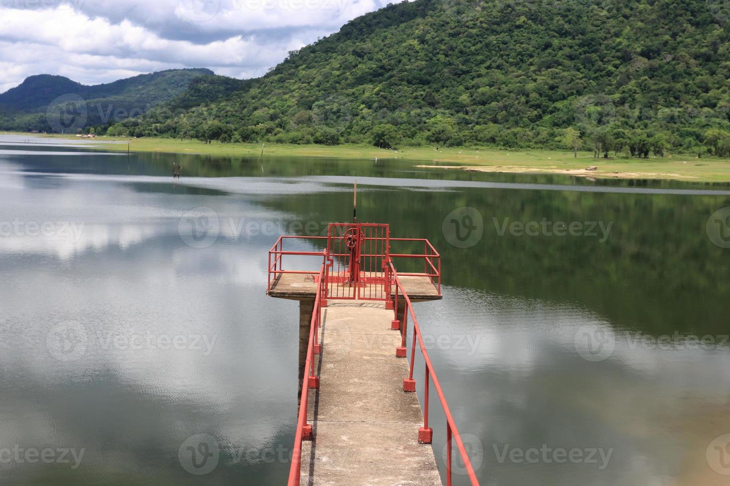 Perspective view of wooden pier at lake. Large bridge in water photo