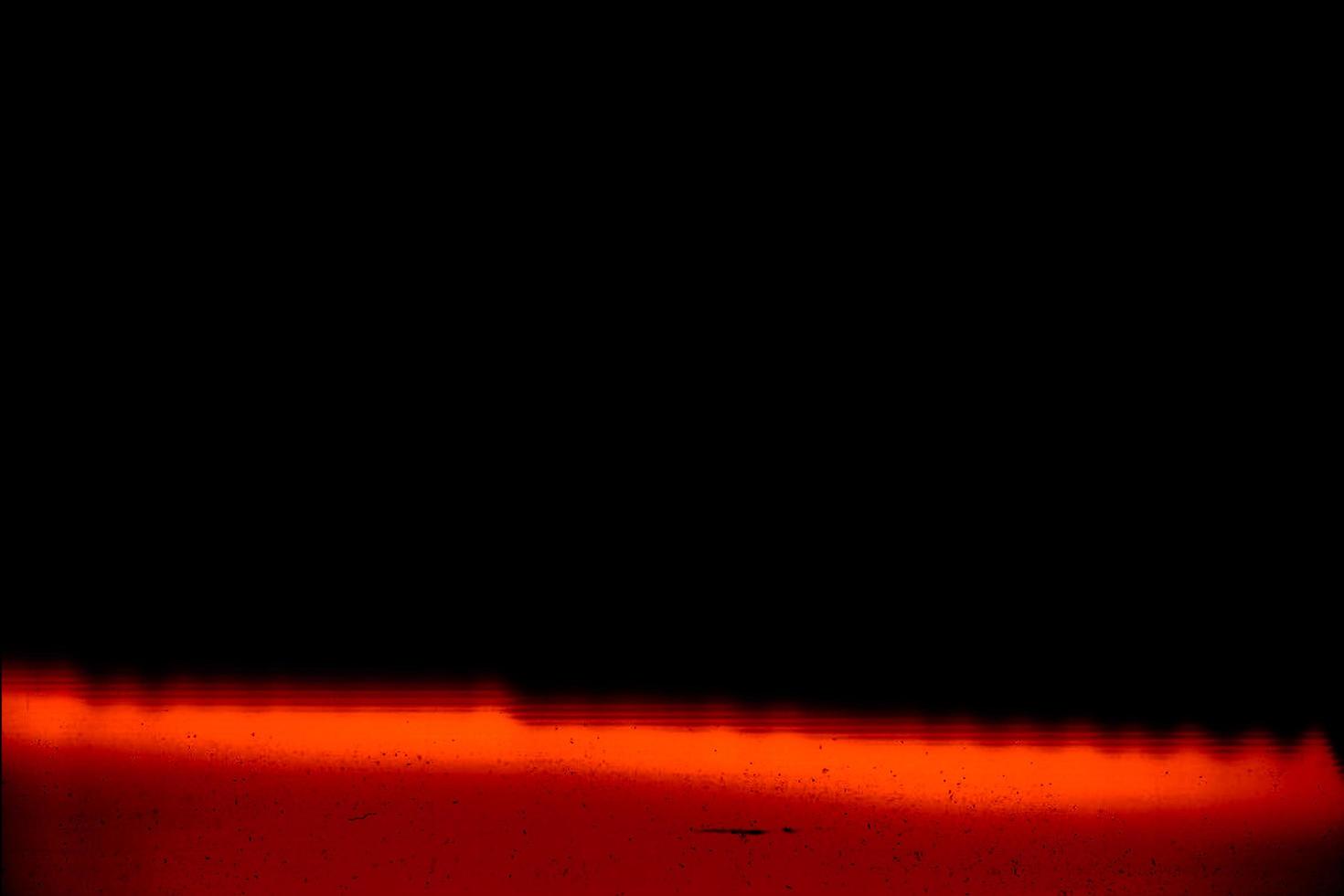 Blank grained and scratched film strip texture background with heavy grain, dust and a light leak Real Lens Flare Shot in Studio over Black Background photo