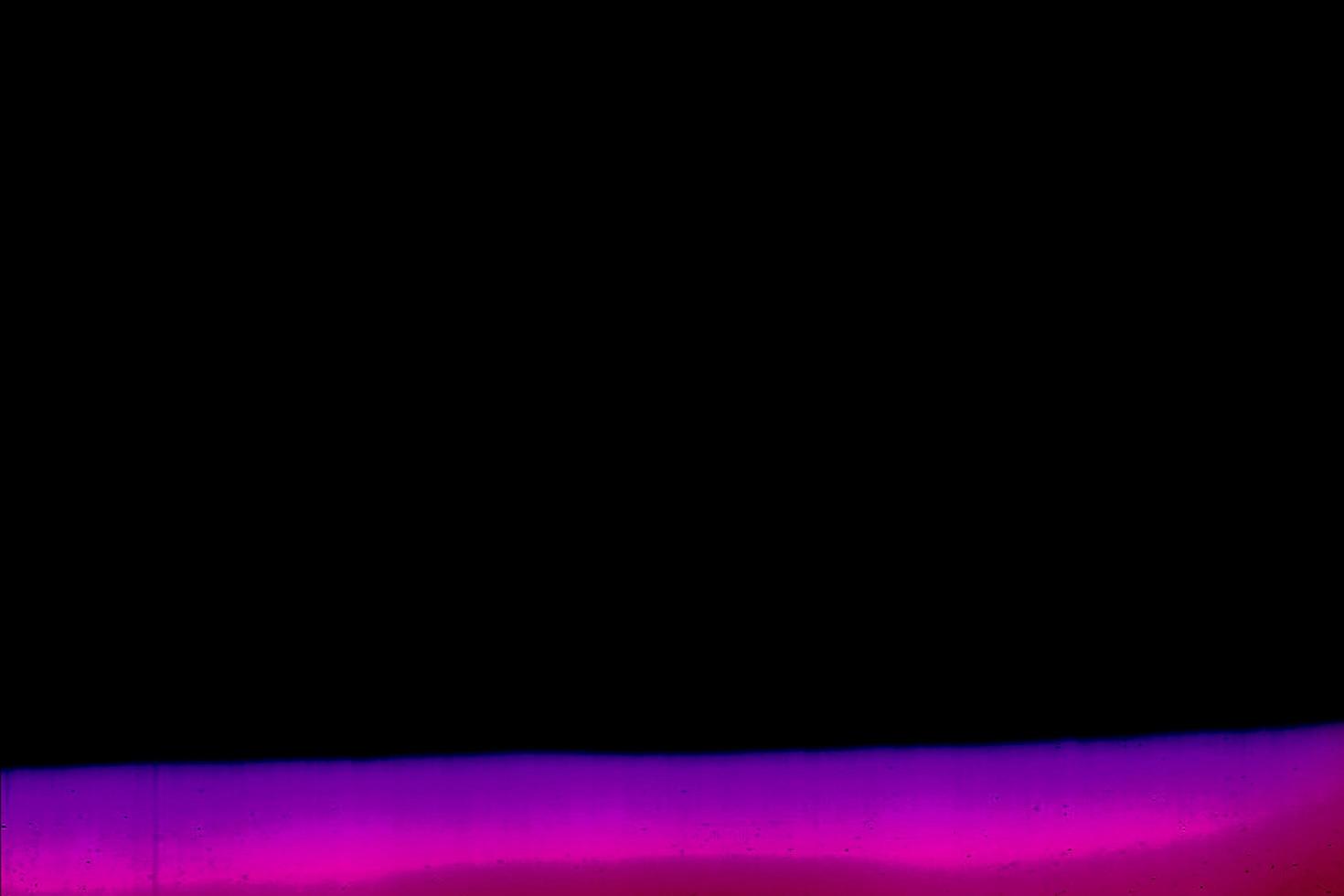 Blank grained and scratched film strip texture background with heavy grain, dust and a light leak Real Lens Flare Shot in Studio over Black Background photo