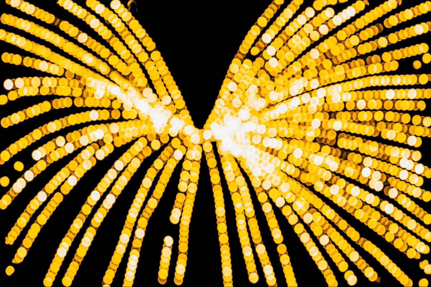 abstract bokeh background of golden light burst made from bokeh motion. photo