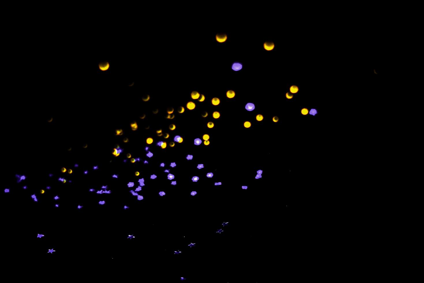 background of abstract glitter lights. gold and black. de focused photo