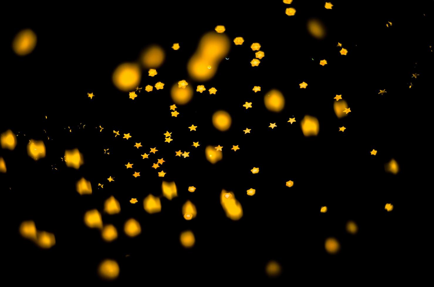 background of abstract glitter lights. gold and black. de focused photo