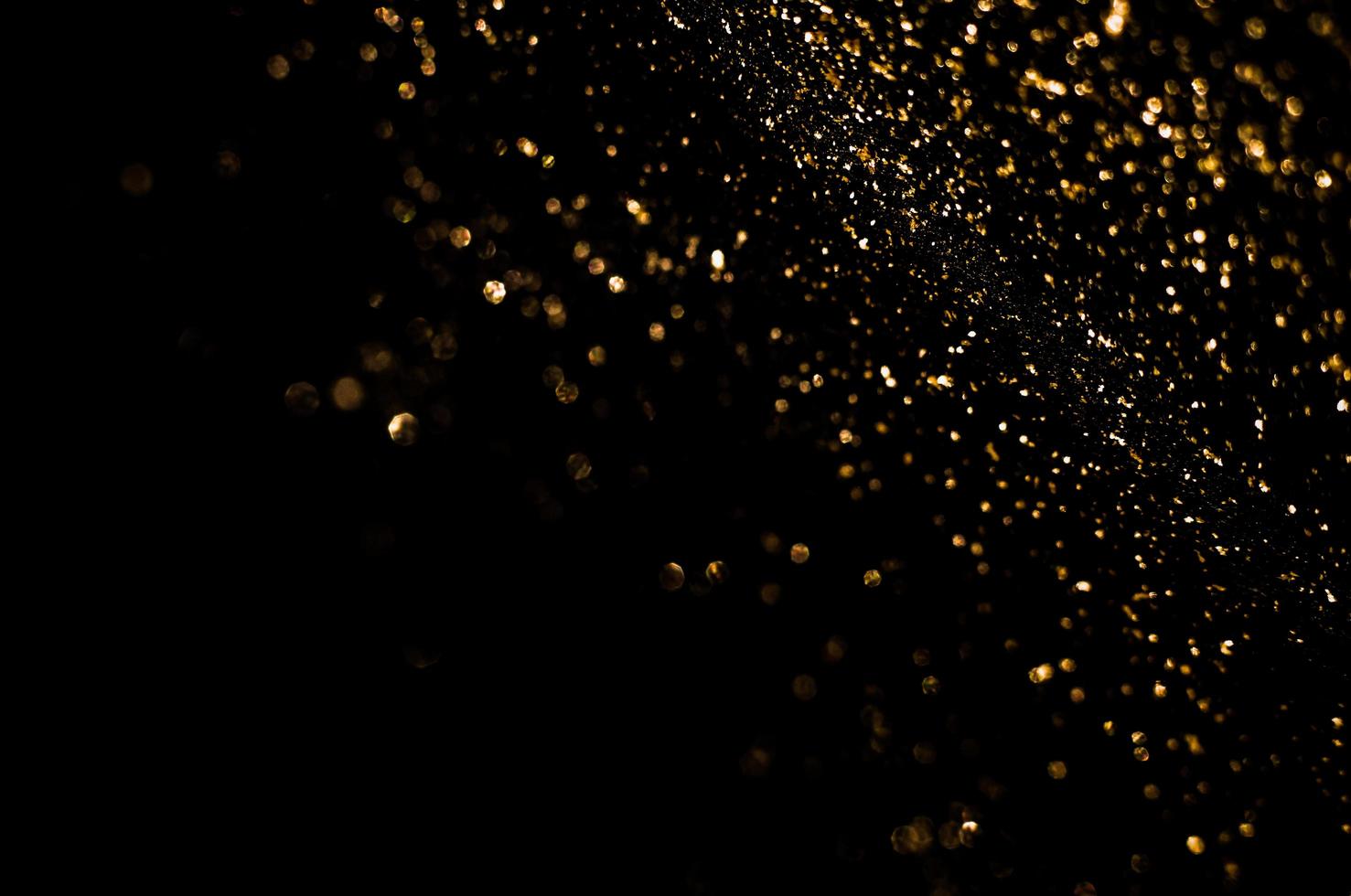 background of abstract glitter lights. gold and black. de focused photo