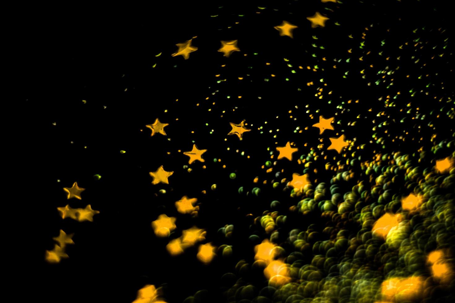 background of abstract glitter lights. gold and black. de focused photo