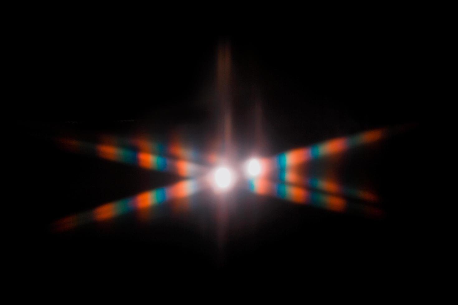 Lens flare and light leak haze texture on a black background. photo